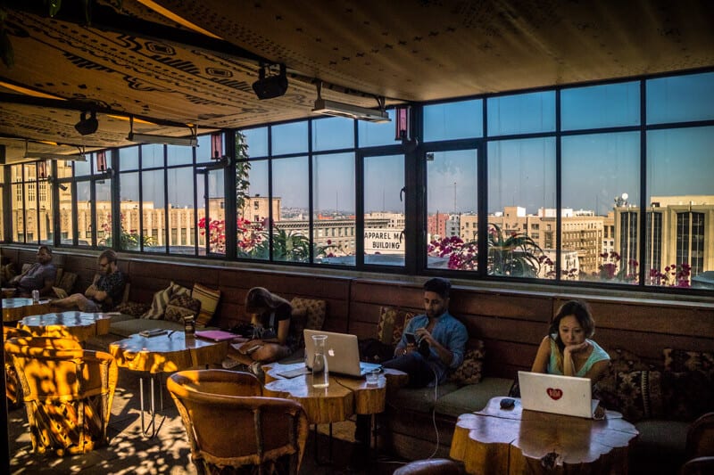 people on laptop in Ace hotel Upstairs rooftop bar (3)