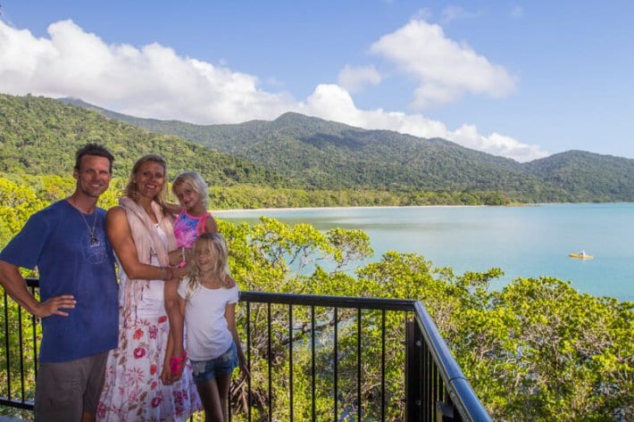 family posing in front of the View of Cape Tribulation Beach from Kulki Lookout in the Daintree Rainforest