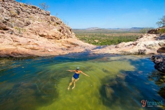 woman swimming in gunlom falls waterhole in kaakdu
