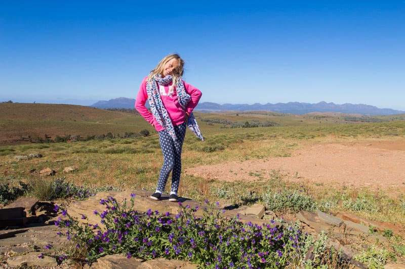girl standing on a dirt hill