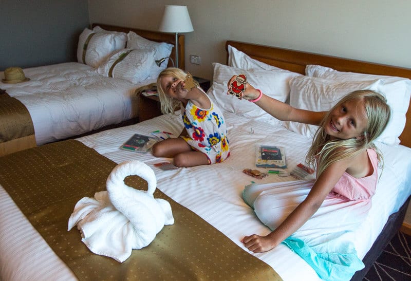 girls sitting on a hotel bed