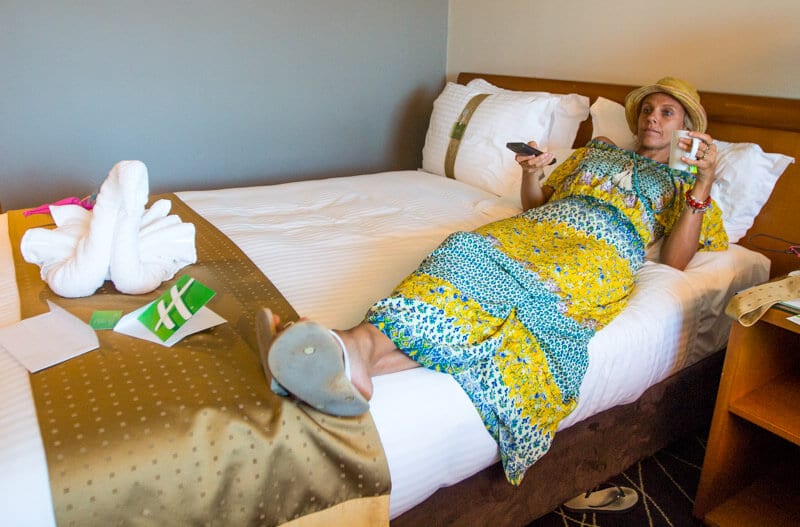 woman sitting on a hotel bed