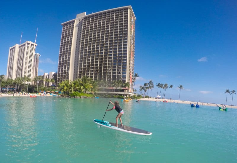 person stand up paddle boarding in the ocean