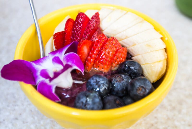 an acai bowl with bananas, strawberries and blueberries