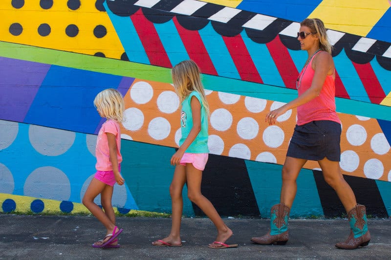 woman and two girls walking in front of colorful Mural in The Gulch, Nashville
