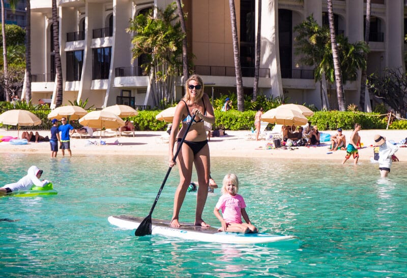 womand child paddlbaording on The lagoon at Hilton Hawaiian Village 