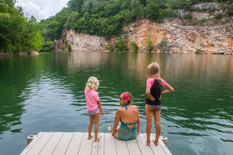 woman and girls sitting on jetty at Mead's Quarry Lake - 