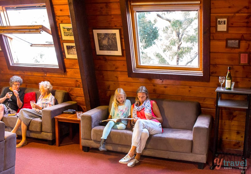 woman and young girl reading sitting on couch in Binna Burra Lodge, Gold Coast Hinterland
