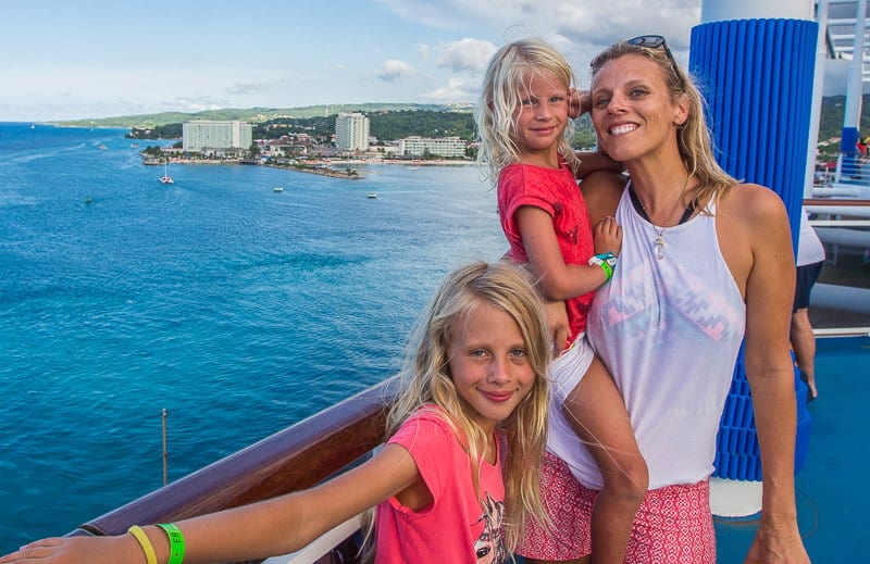 family posing on cruise ship in front of Ochos Rios Caribbean Carnival Vista Cruise (1)