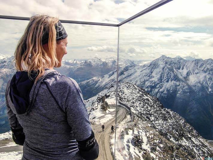 woman looking at snow capped mountain view in Austria