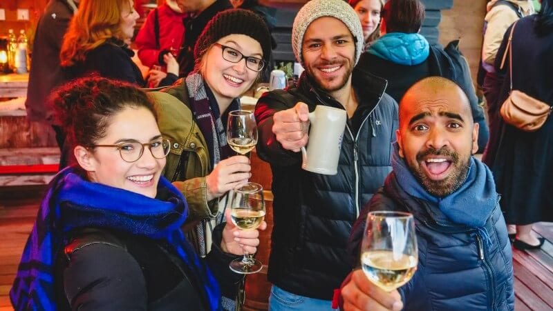 people holding drinks and smiling