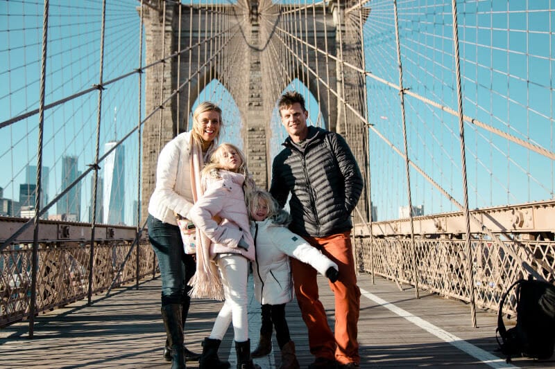 family posing for camera on the  Brooklyn Bridge 