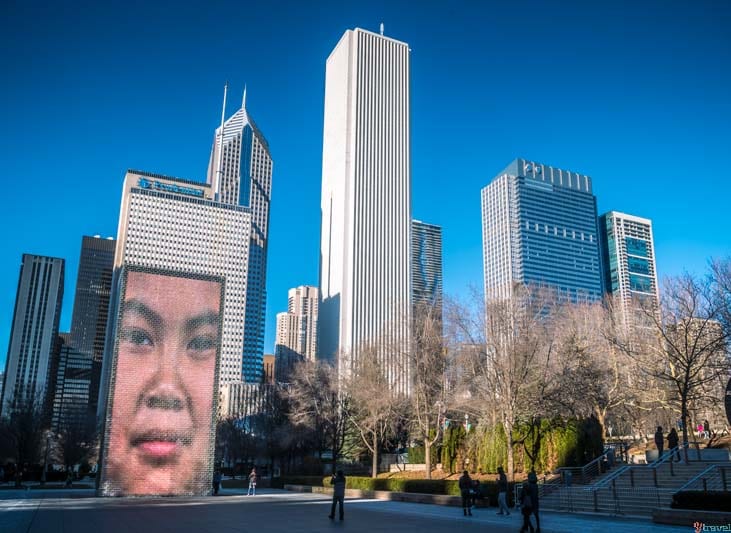 tall city buildings with human face on them