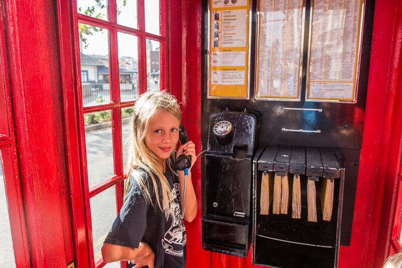 girl standing in a telephone booth