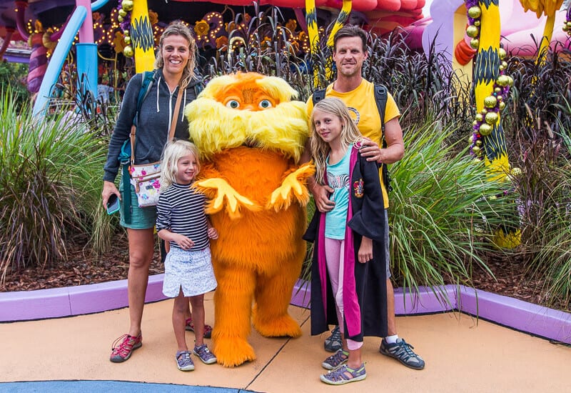 family posing with the lorax at universal