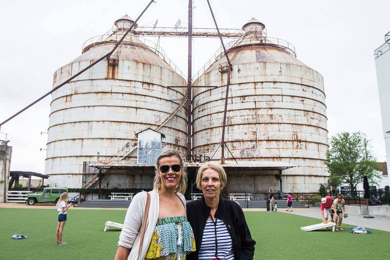 people standing in front of silos
