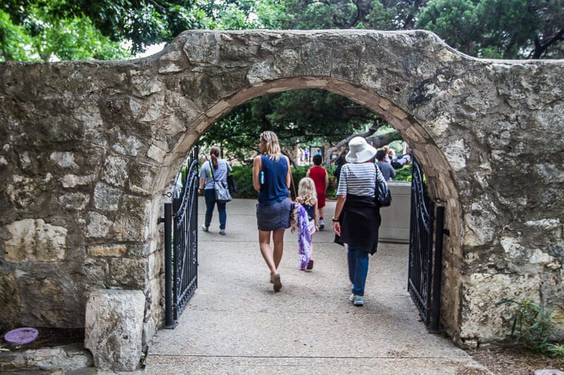 people walking through the gates of the Alamo 