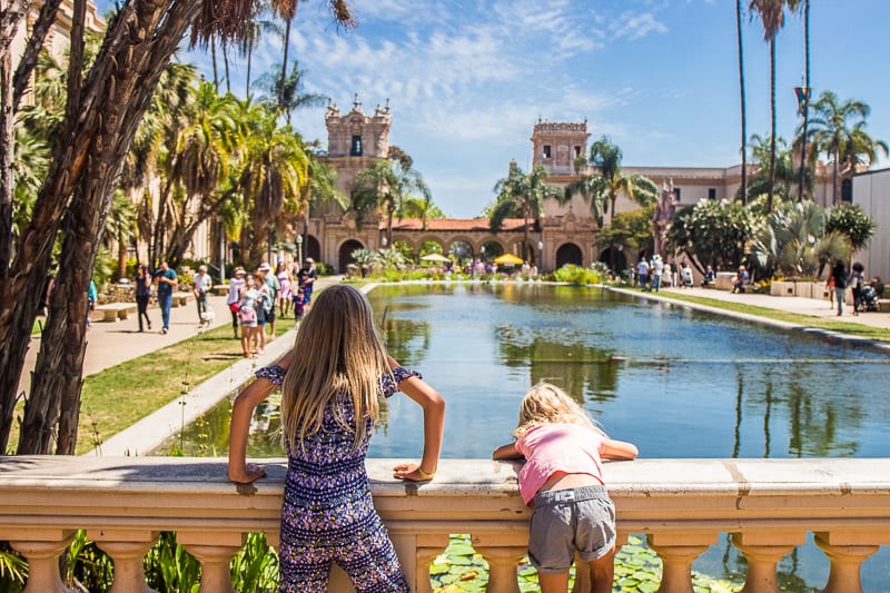two girls looking at view of pind and historica building in Balboa Park, San Diego, California