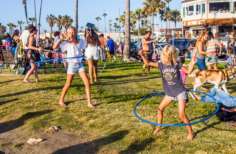 kids hula hooping connected  grass