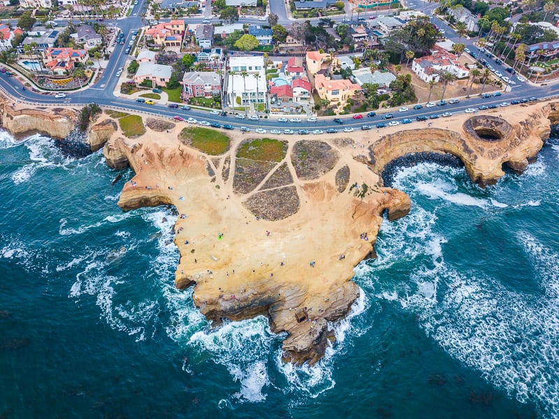aerial presumption    of Sunset Cliffs with roadworthy  winding on  and homes