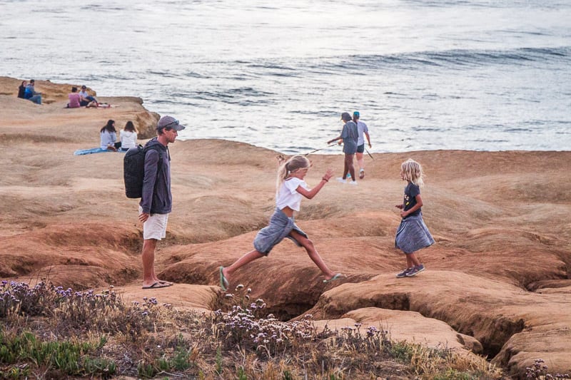 kids playing connected  the Sunset Cliffs 