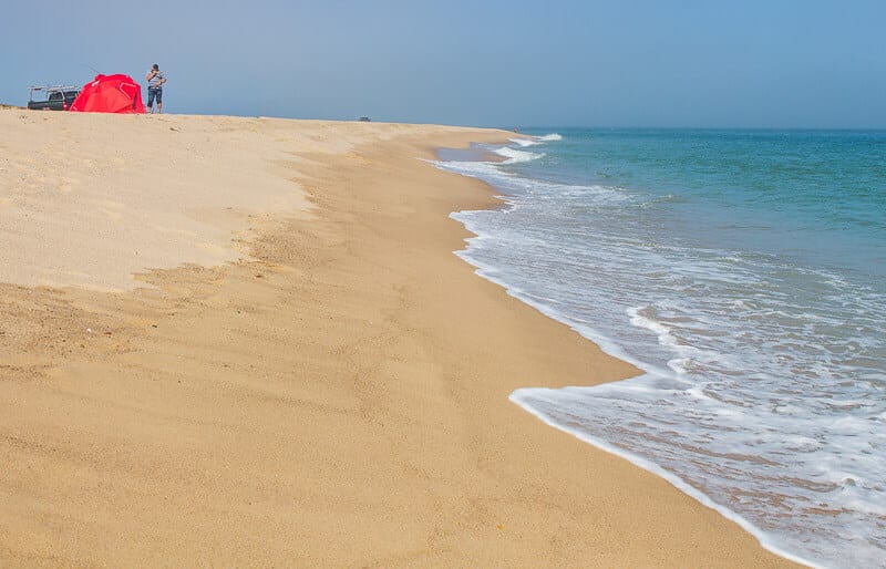 A sandy beach next to the ocean