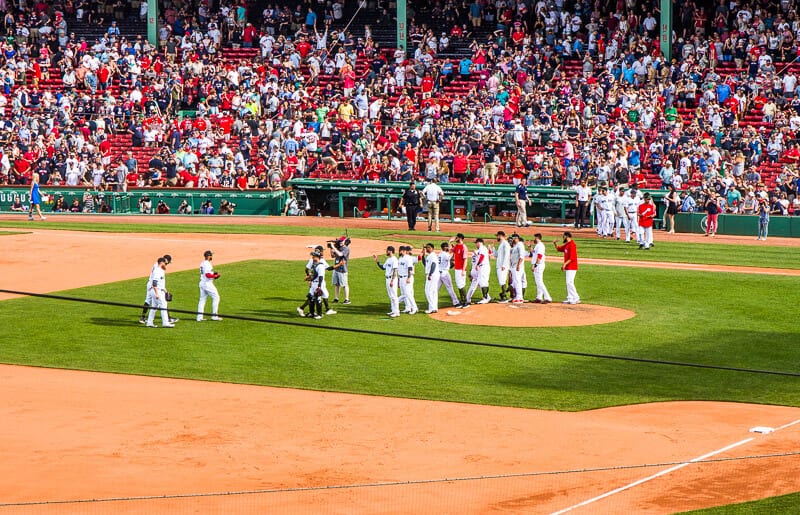 Red sox baseball team on the field with spectactors cheering