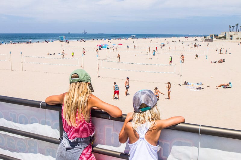 girls looking at huntington beach and volleyball courts