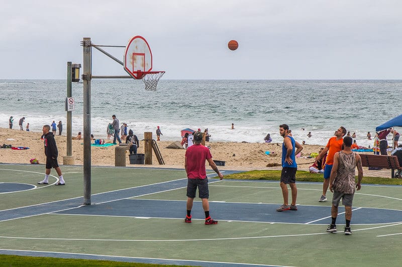 people playing basketball on beach
