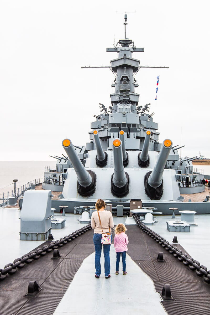 people standing on an old battleship