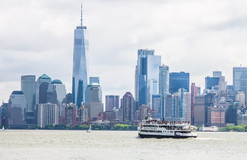 view of manhattan with ferry on river