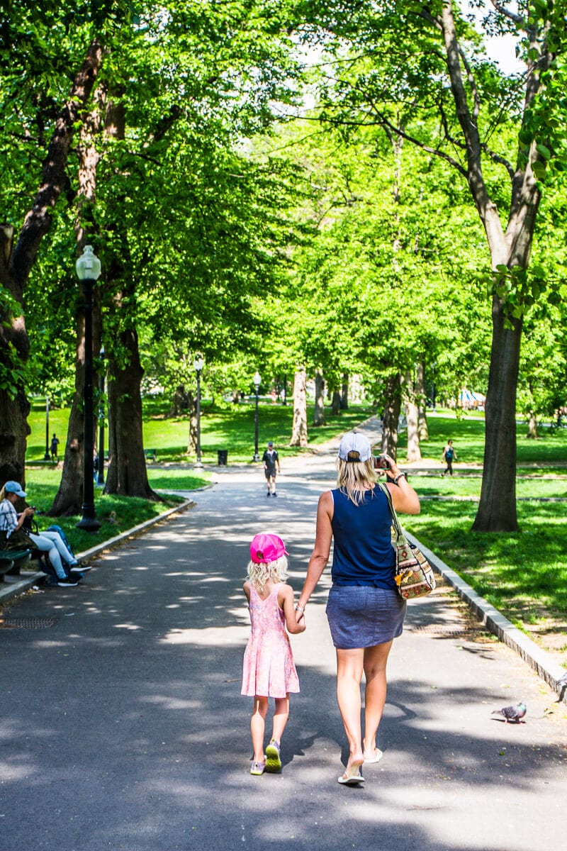 woman andgirl walking along tree lined path in Boston Common