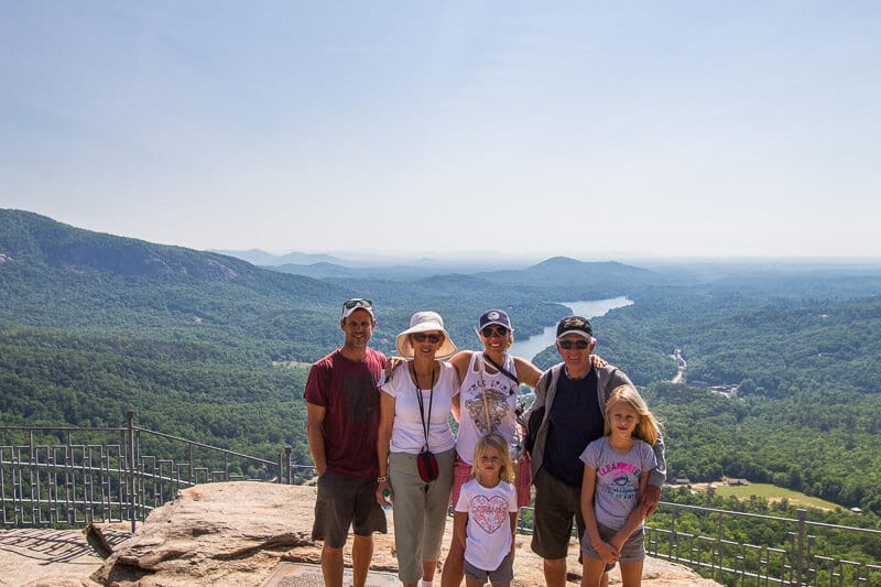family posing on Chimney Rock with view of lake lure