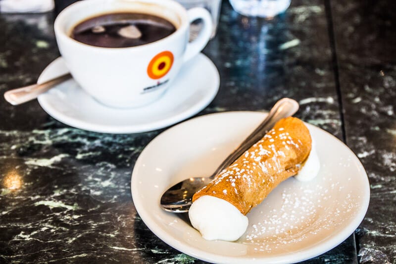  coffee and Cannoli  on a balck table