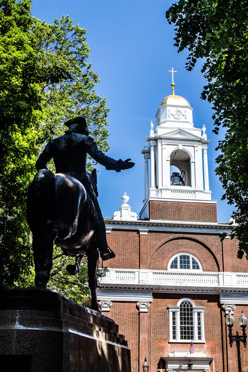 statue of paul reverre looking at the steeple of Old North Church