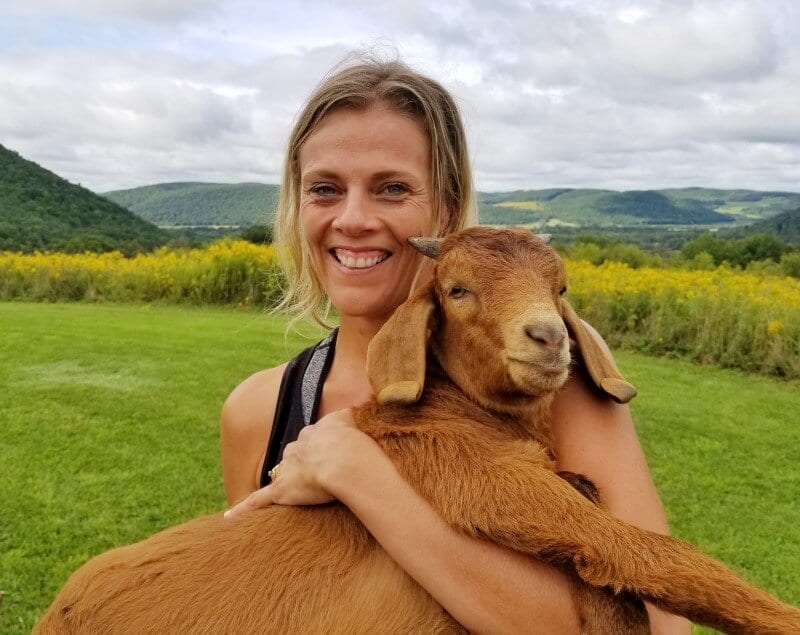 Caz cuddling a goat
