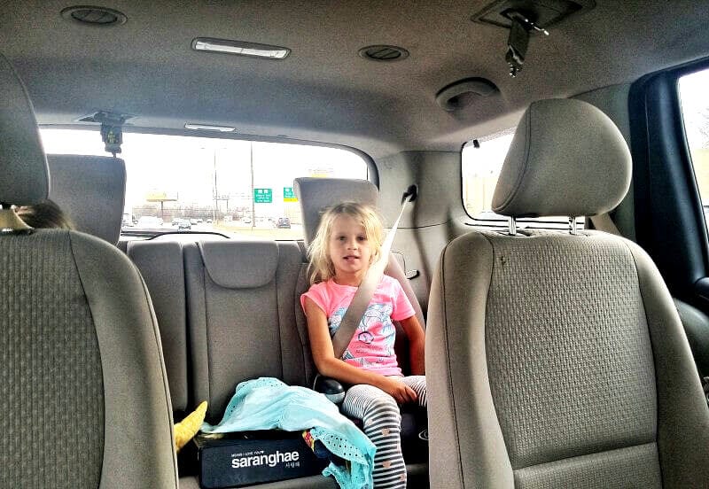 girl sitting in a car seat 