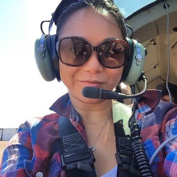woman with headset on in helicopter