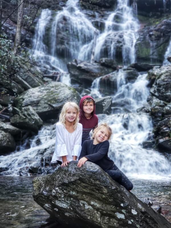 kids posing on rock at catawba falls asheville