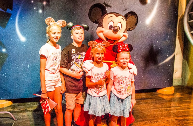 kids standing with mickey mouse