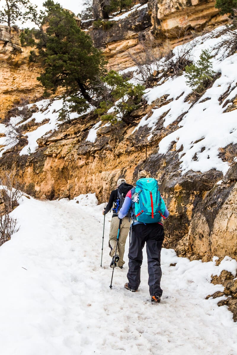 people walking in a snowy canyon