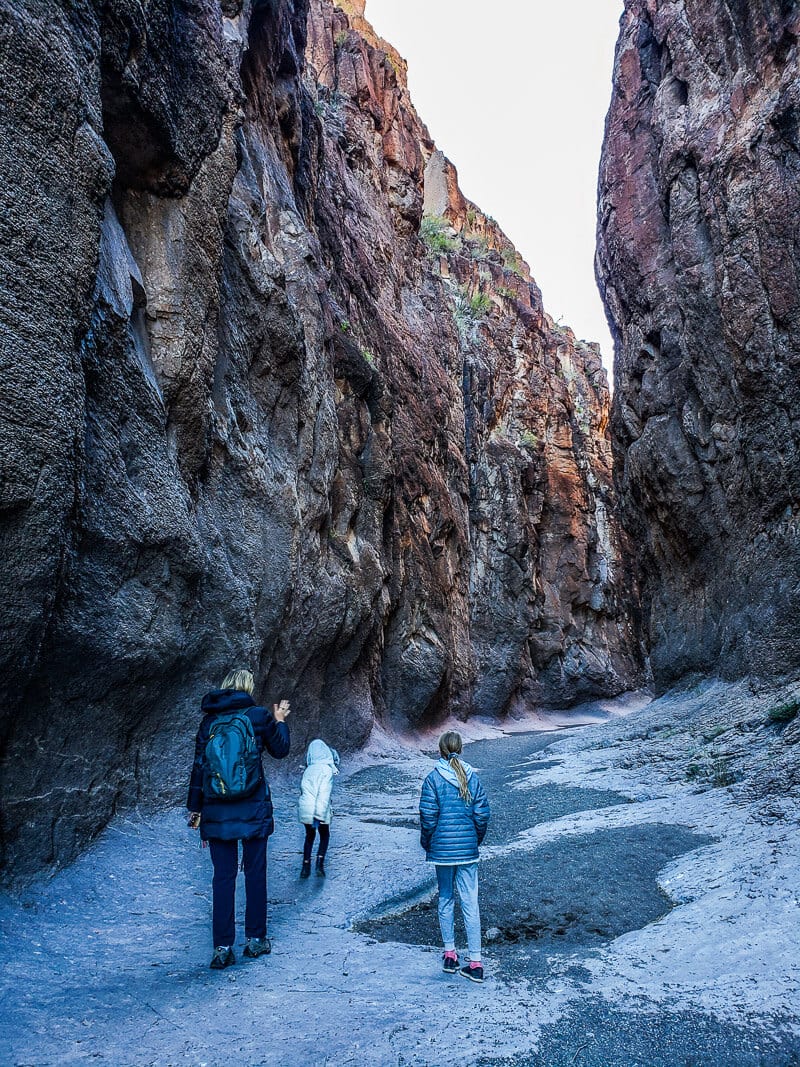 caz and girls walking through Closed Canyon with sheer rock walls