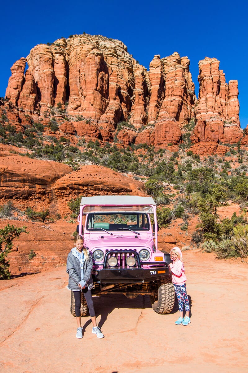 pink jeep  driving in a canyon