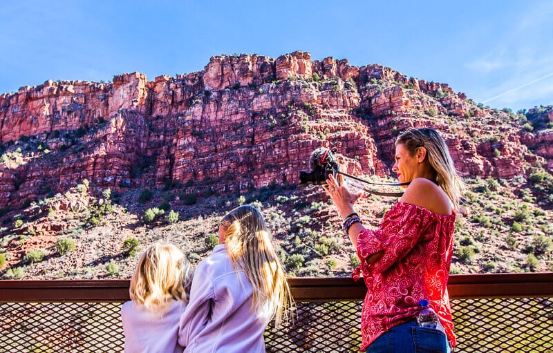 woman taking photo of girls looking at the view on the Verde Canyon Railroad 