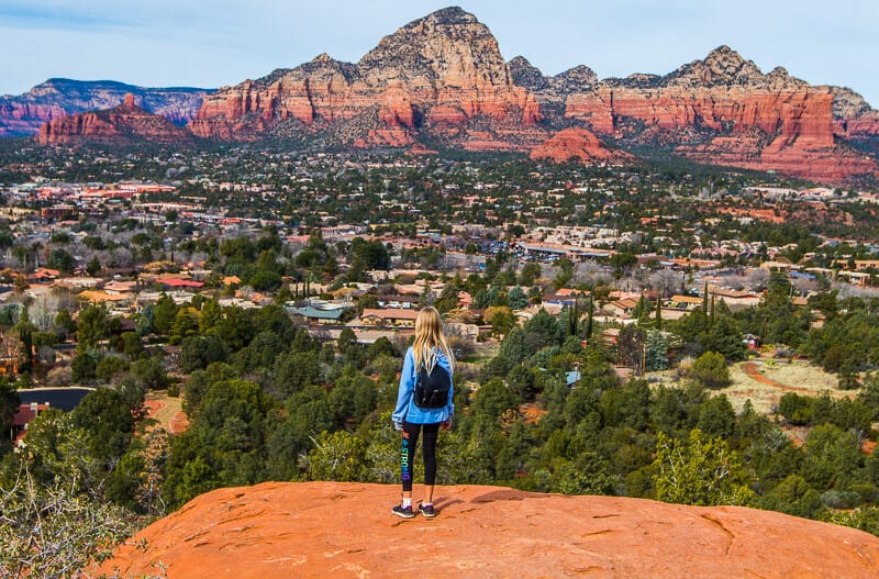 girl looking at red mountain peaks