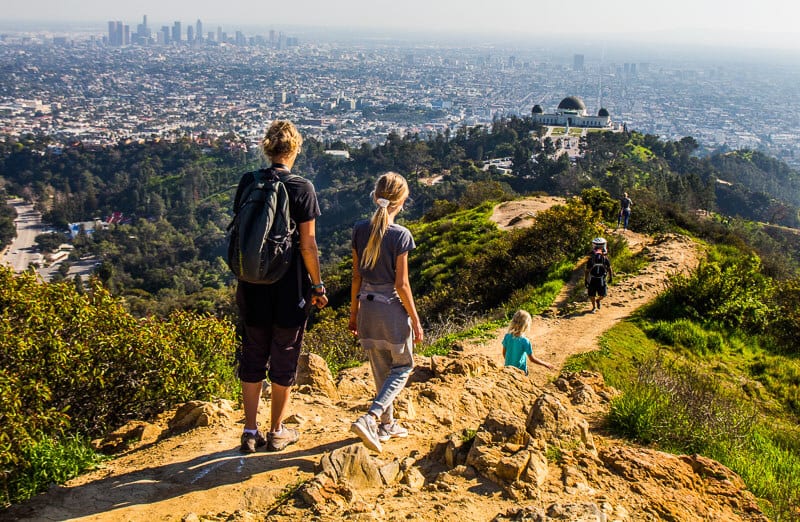 people hiking in griffith park with views of la