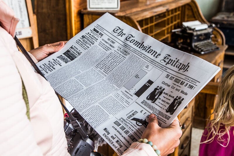 person holding an old newspaper