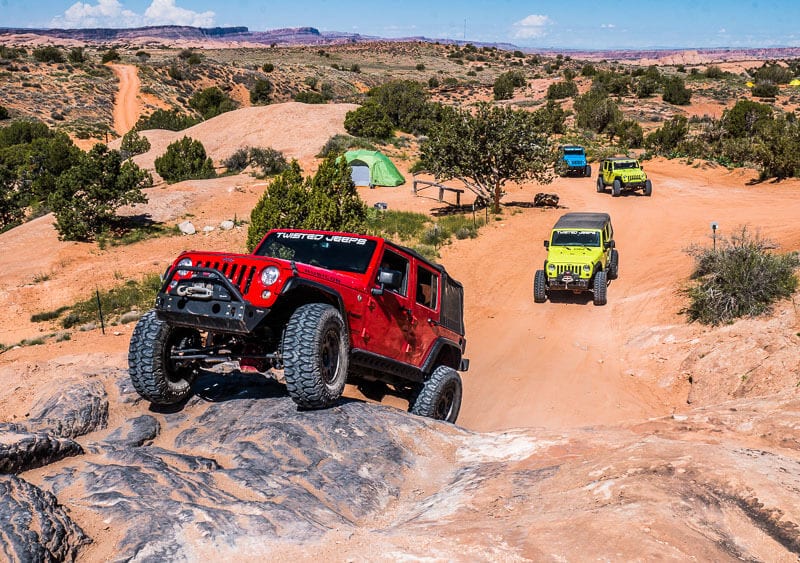 jeep climbing over rocks  Moab Utah