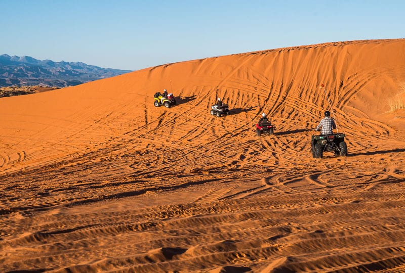 quad bikes driving up dand dunes