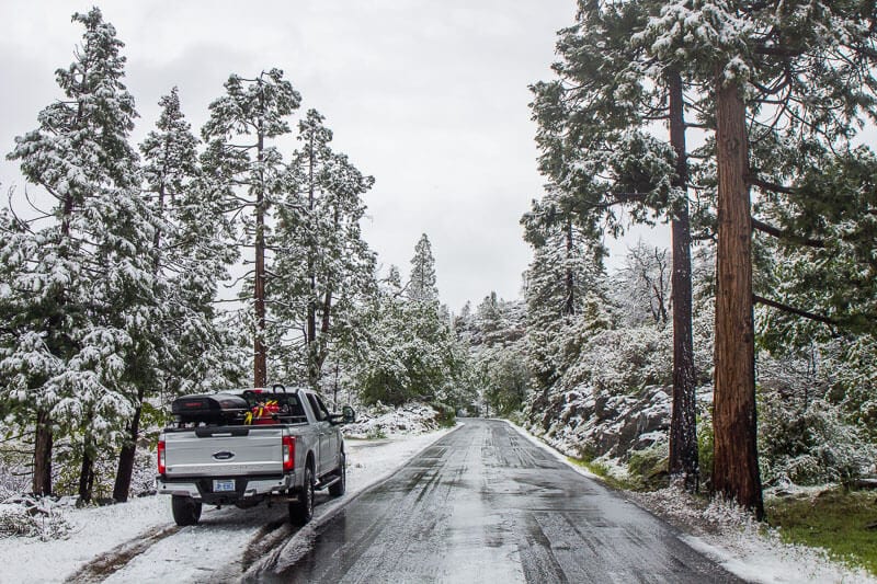 truck on snow covered road into hetch hetchy yosemite